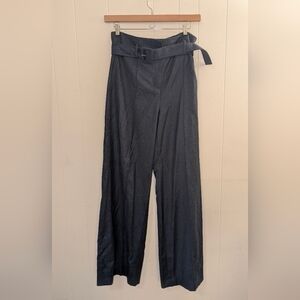 Theory wide-leg flannel pants crafted in 100% virgin wool with integrated belt.